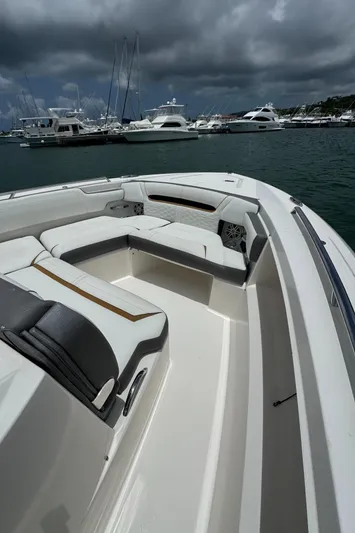  Yacht Photos Pics 2020 Tiara Sport 34 LS boat interior with luxurious seating, docked in a marina under cloudy skies.