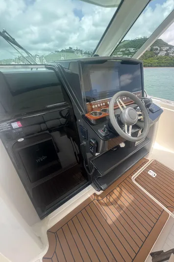  Yacht Photos Pics 2020 Tiara Sport 34 LS helm with modern controls and wood flooring.