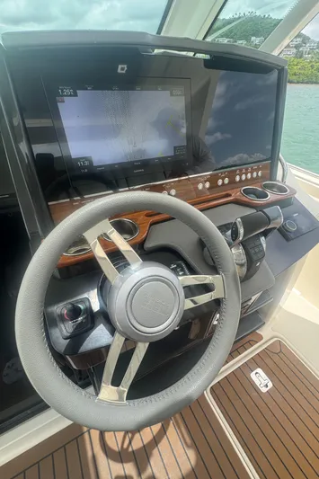  Yacht Photos Pics Steering wheel and dashboard of 2020 Tiara Sport 34 LS boat, featuring navigation display.