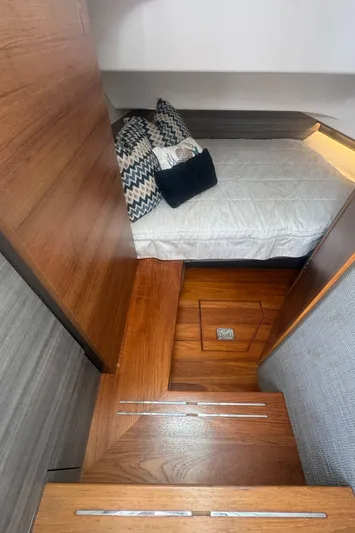  Yacht Photos Pics 2020 Tiara Sport 34 LS cabin interior with wooden steps and cozy bedding.