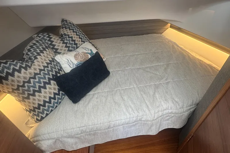  Yacht Photos Pics Cozy cabin bed in 2020 Tiara Sport 34 LS with decorative pillows and soft lighting.
