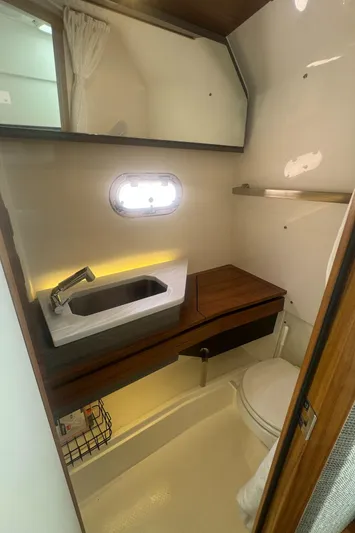  Yacht Photos Pics 2020 Tiara Sport 34 LS boat bathroom with sink, toilet, and window.