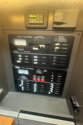  Yacht Photos Pics Control panel of a 2020 Tiara Sport 34 LS boat, featuring AC and DC systems.