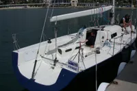 Sailboat docked at marina, Custom IMS proto 33', 1997 model, for sale sign visible.