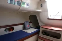 Interior of 1997 Custom IMS proto 33' sailboat with seating and storage.