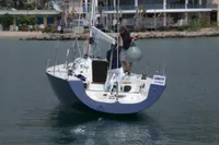 Sailboat "IMS proto 33'" 1997 model, docked with people on deck, for sale sign visible.