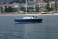 Sailboat "IMS proto 33'" on calm water near a coastal town, 1997 model.