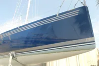Custom 1997 IMS proto 33' sailboat with blue hull and white stripes.