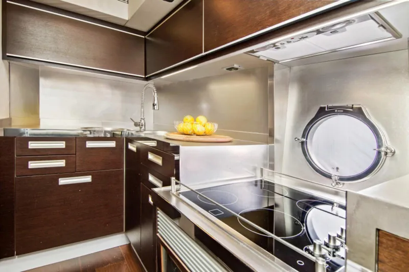  Yacht Photos Pics Luxurious kitchen interior of 2009 Azimut 68S yacht with modern appliances and sleek design.