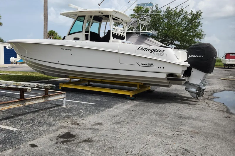 Outrageous Yacht Photos Pics 2014 Boston Whaler 350 Outrage boat on a trailer in a parking lot.