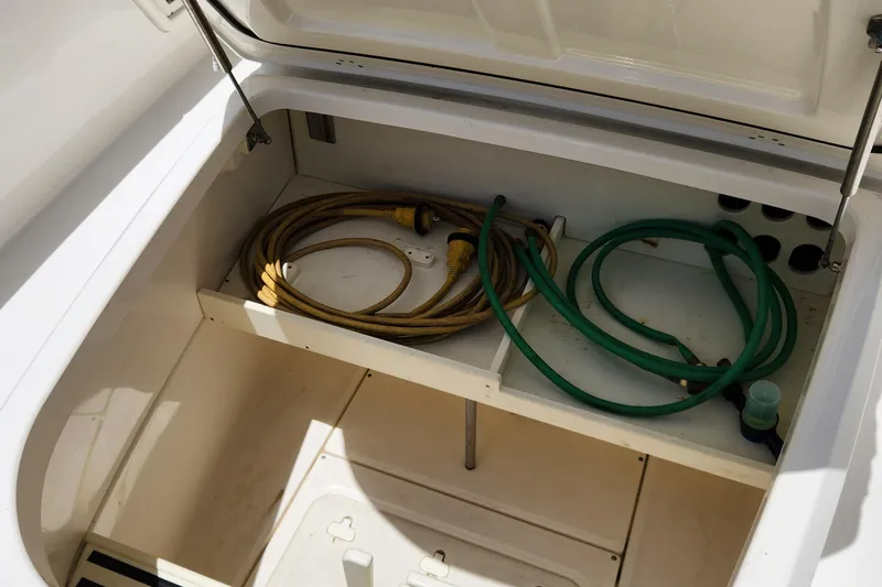 Outrageous Yacht Photos Pics Storage compartment of a 2014 Boston Whaler 350 Outrage boat with hoses.