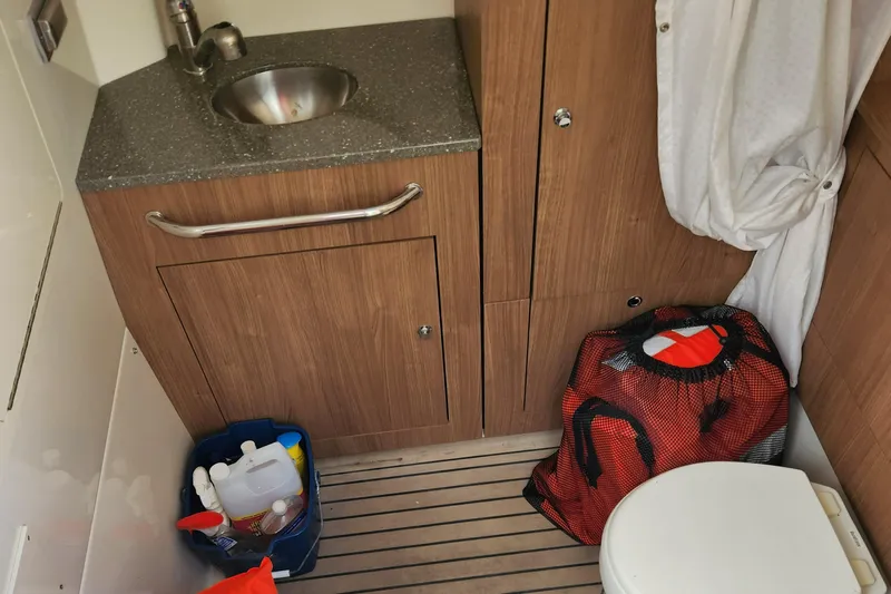 Outrageous Yacht Photos Pics 2014 Boston Whaler 350 Outrage bathroom with sink, storage cabinets, and toilet.