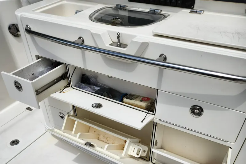 Outrageous Yacht Photos Pics Boston Whaler 350 Outrage 2014 boat storage compartments and sink area.
