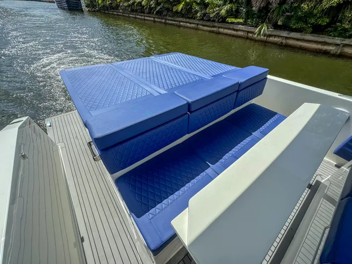  Yacht Photos Pics 2024 De Antonio Yachts D28 Open with blue cushioned seating on deck.