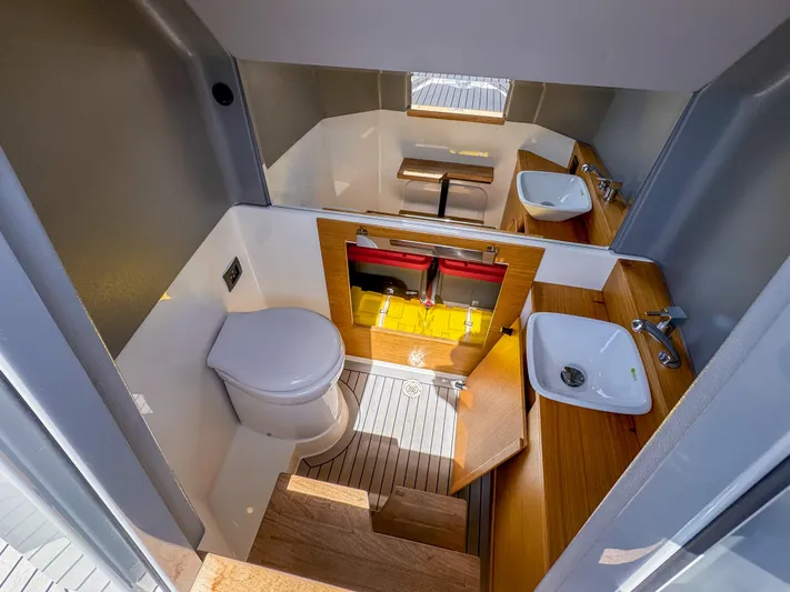  Yacht Photos Pics 2024 De Antonio Yachts D28 Open interior with modern bathroom and wooden accents.