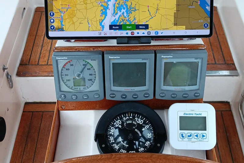 Rhythm Yacht Photos Pics Navigation instruments on a 1991 Gozzard 31 yacht, featuring Raymarine displays and a compass.
