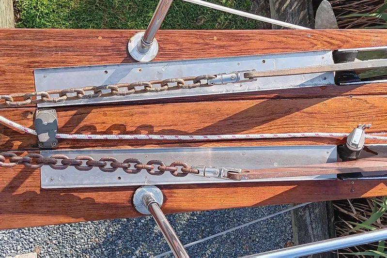 Rhythm Yacht Photos Pics Deck hardware of a 1991 Gozzard 31 sailboat, featuring chains and ropes on wood.