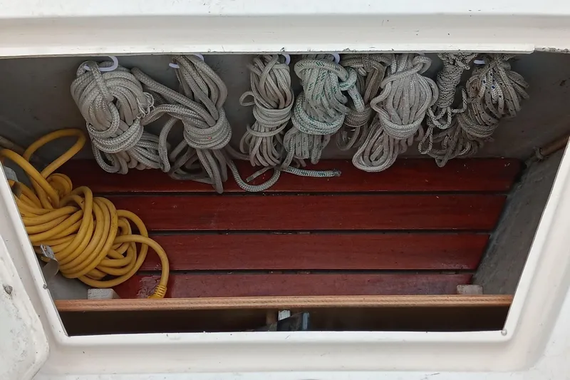 Rhythm Yacht Photos Pics Coiled ropes in a storage compartment of a 1991 Gozzard 31 sailboat.