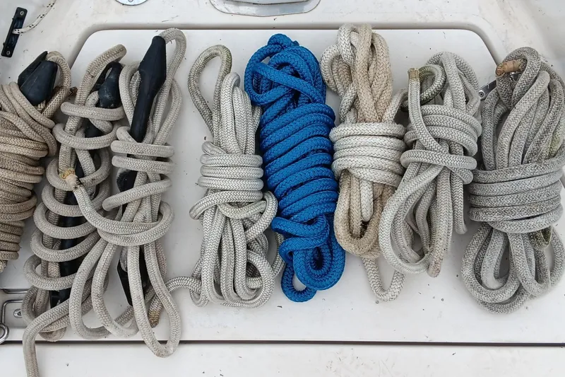 Rhythm Yacht Photos Pics Coiled ropes on a 1991 Gozzard 31 boat deck, featuring a vibrant blue line.