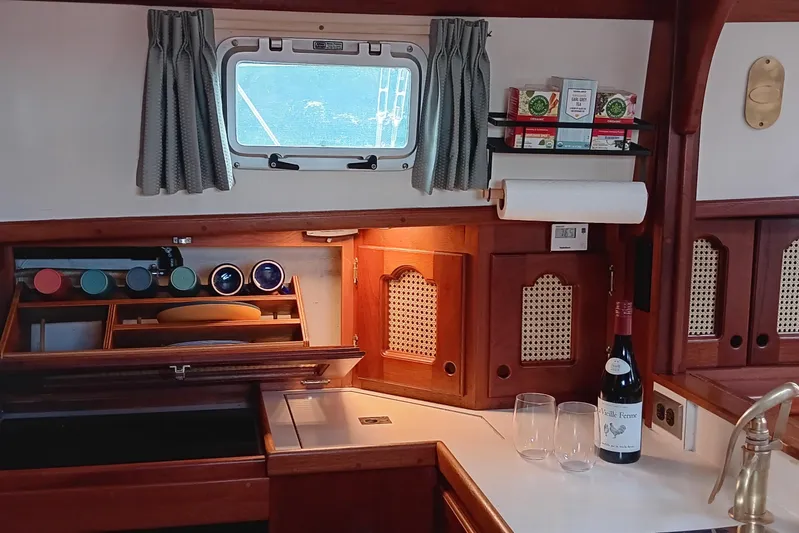 Rhythm Yacht Photos Pics Cozy 1991 Gozzard 31 yacht interior with wooden cabinetry and kitchen essentials.