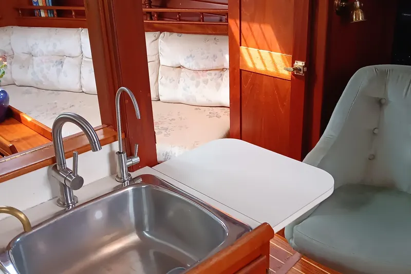 Rhythm Yacht Photos Pics Interior of 1991 Gozzard 31 yacht with sink, seating, and wooden accents.