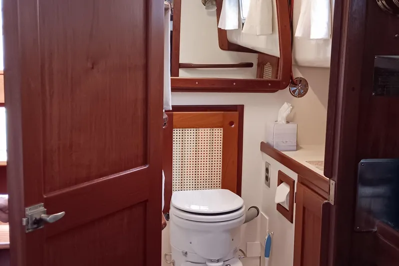 Rhythm Yacht Photos Pics 1991 Gozzard 31 yacht bathroom with wooden accents and nautical decor.