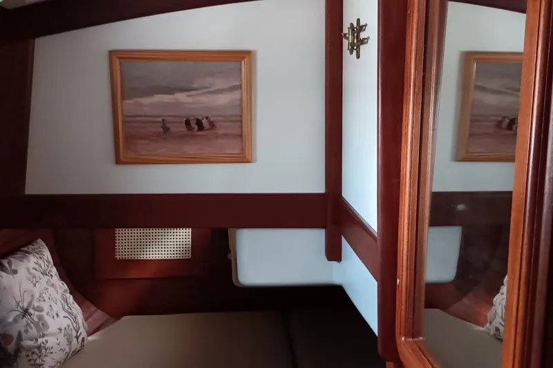 Rhythm Yacht Photos Pics Cozy cabin interior of 1991 Gozzard 31 sailboat with framed artwork and wooden accents.