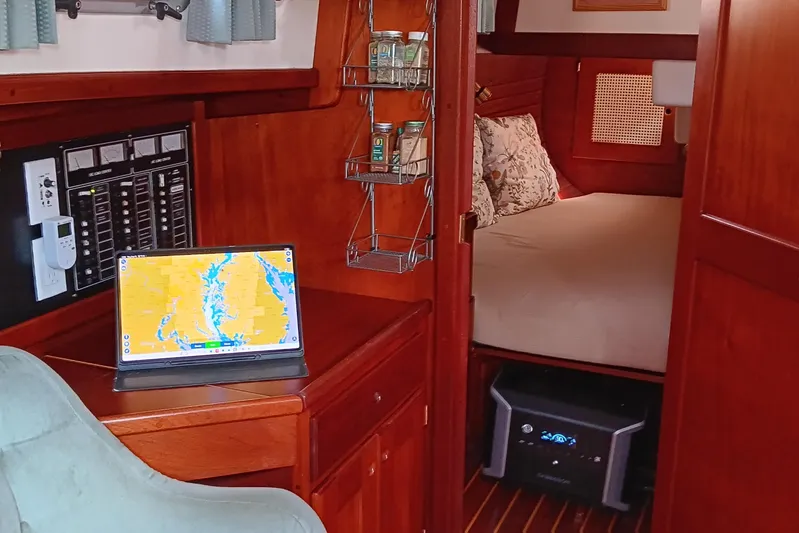 Rhythm Yacht Photos Pics Cozy interior of a 1991 Gozzard 31 sailboat with navigation setup and comfortable sleeping area.