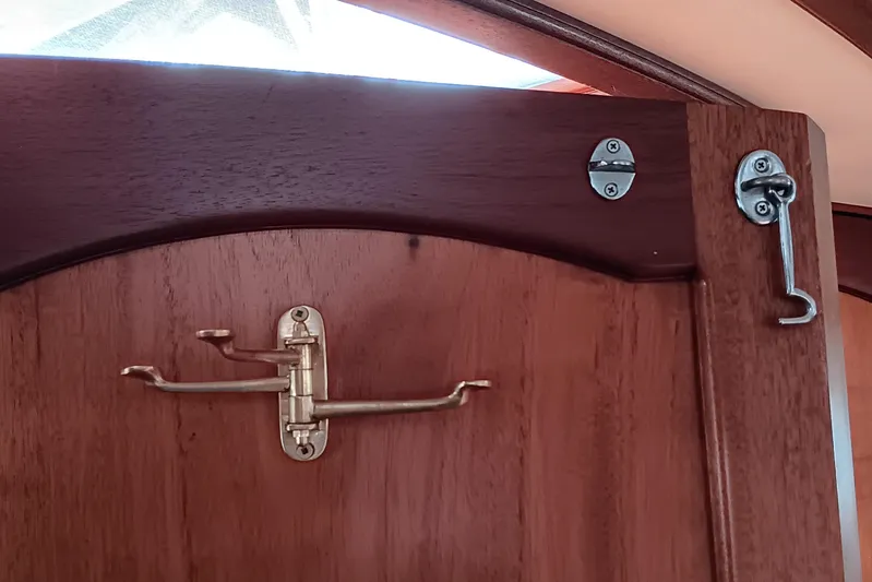 Rhythm Yacht Photos Pics Wooden door with brass latch and hook on a 1991 Gozzard 31 boat.