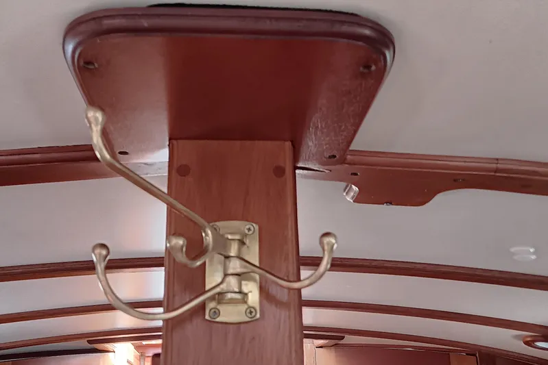 Rhythm Yacht Photos Pics Brass coat hook on wooden interior of 1991 Gozzard 31 boat.