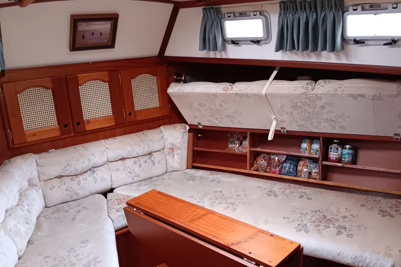 Rhythm Yacht Photos Pics Interior of 1991 Gozzard 31 sailboat with cozy seating and storage compartments.