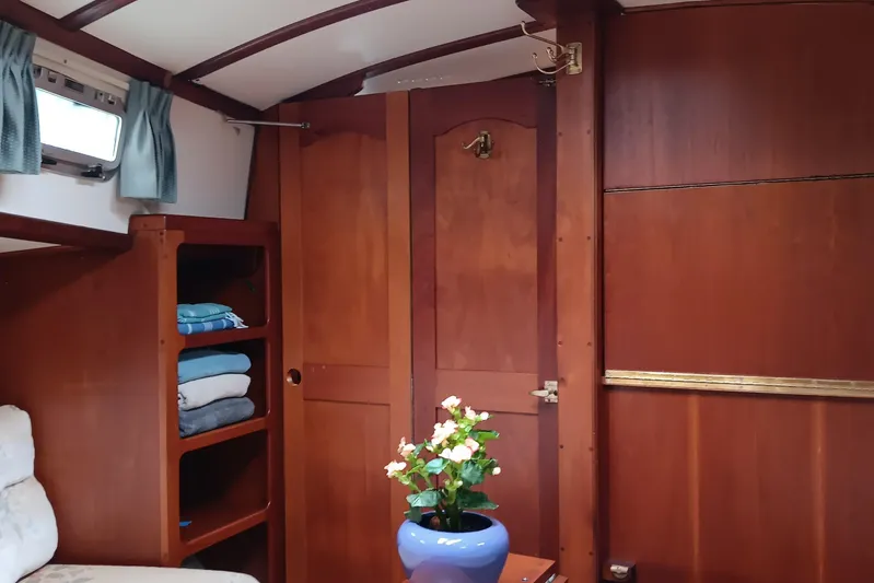 Rhythm Yacht Photos Pics Interior of 1991 Gozzard 31 sailboat with wooden cabinetry and floral decor.