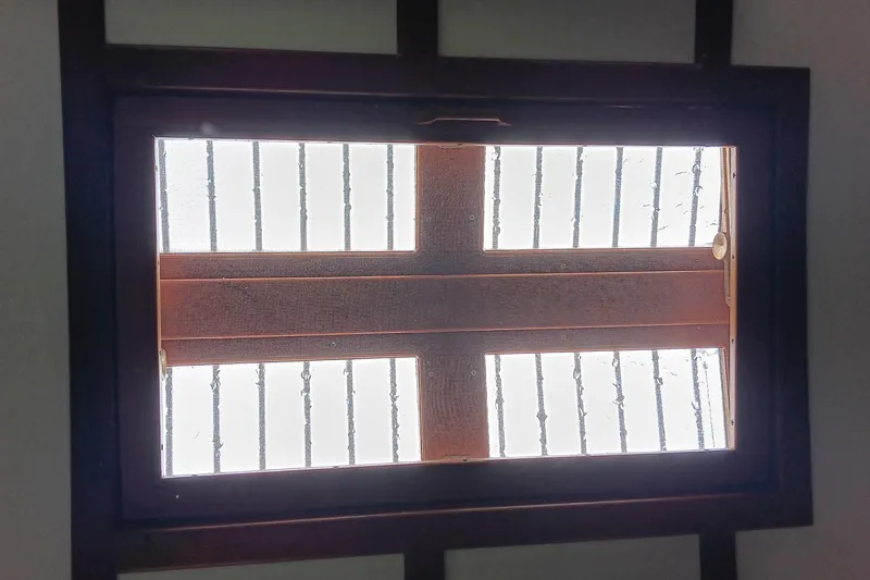 Rhythm Yacht Photos Pics Skylight view from a 1991 Gozzard 31 boat, featuring wooden frame and metal bars.