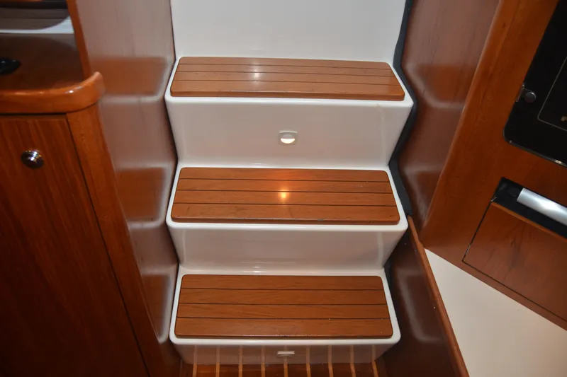 Sea Time Yacht Photos Pics Wooden steps inside a 2001 Tiara Yachts 4100 Open, featuring elegant design and craftsmanship.