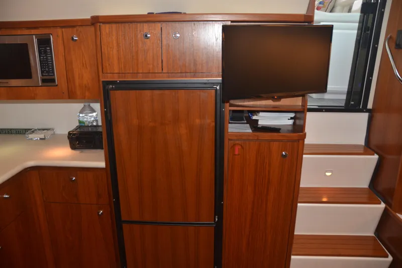 Sea Time Yacht Photos Pics Interior of 2001 Tiara Yachts 4100 Open with wood cabinetry and modern appliances.