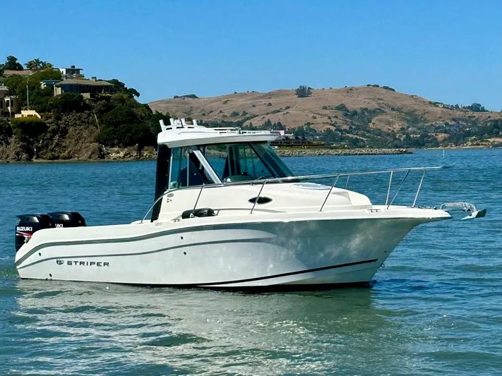 Empty Nest Yacht Photos Pics 2012 Seaswirl Striper 2601 Walkaround boat on calm water, scenic background.