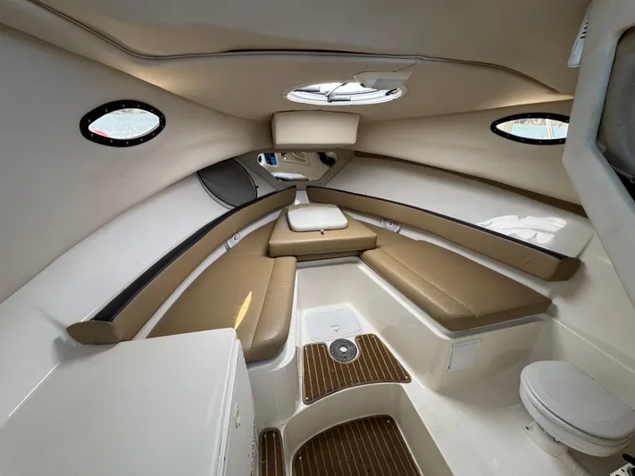 Empty Nest Yacht Photos Pics 2012 Seaswirl Striper 2601 Walkaround cabin interior with seating and portholes.
