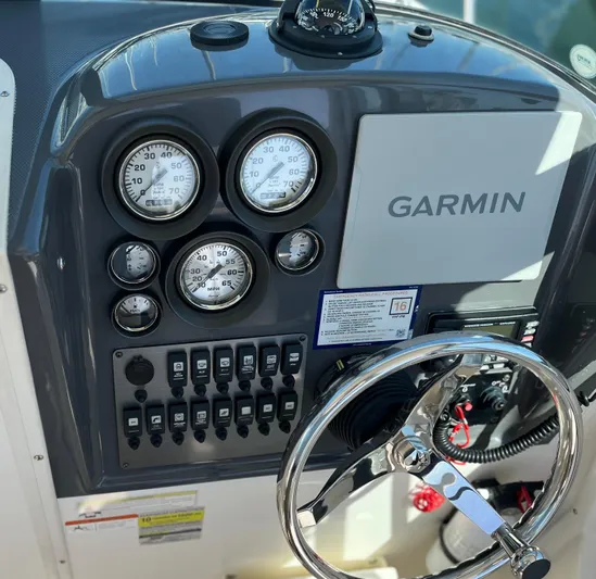 Empty Nest Yacht Photos Pics 2012 Seaswirl Striper 2601 Walkaround dashboard with Garmin navigation and gauges.