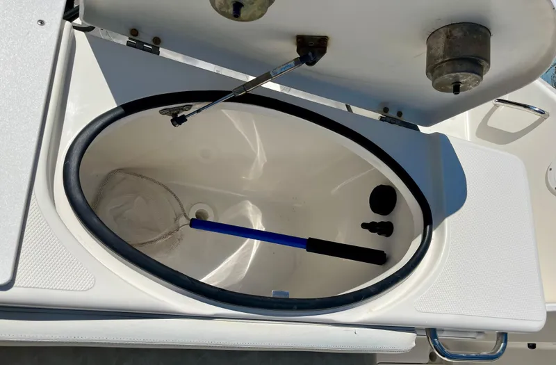 Empty Nest Yacht Photos Pics Open storage compartment on 2012 Seaswirl Striper 2601 Walkaround boat with net inside.