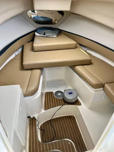 Empty Nest Yacht Photos Pics 2012 Seaswirl Striper 2601 Walkaround cabin interior with beige seating and wood flooring.