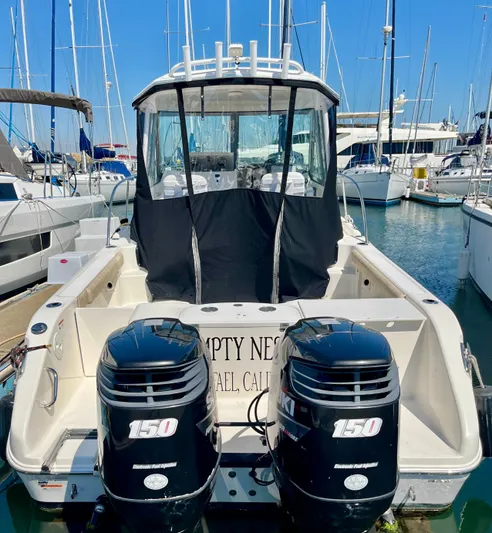 Empty Nest Yacht Photos Pics 2013 Seaswirl Striper 2601 Walkaround boat with dual 150 horsepower engines docked at marina.