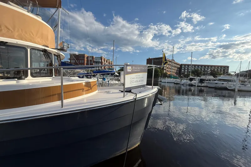  Yacht Photos Pics 2024 Ranger Tugs R31CB docked at marina under blue sky.