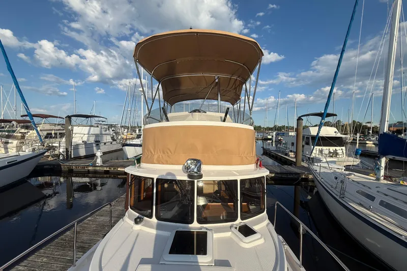  Yacht Photos Pics 2024 Ranger Tugs R31CB boat docked at marina under clear blue sky.