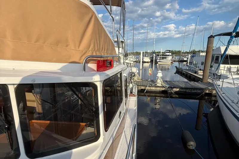  Yacht Photos Pics 2024 Ranger Tugs R31CB docked at marina under blue sky.