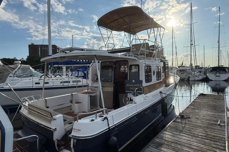  Yacht Photos Pics 2024 Ranger Tugs R31CB docked at marina, sunlit with clear sky.