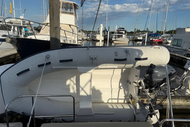  Yacht Photos Pics 2024 Ranger Tugs R31CB docked with inflatable boat and outboard motor.