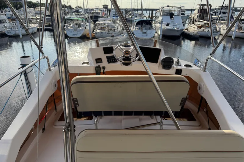  Yacht Photos Pics 2024 Ranger Tugs R31CB boat helm with marina view, showcasing steering and controls.