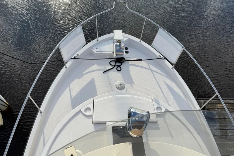  Yacht Photos Pics 2024 Ranger Tugs R31CB boat deck with railing, docked on calm water.