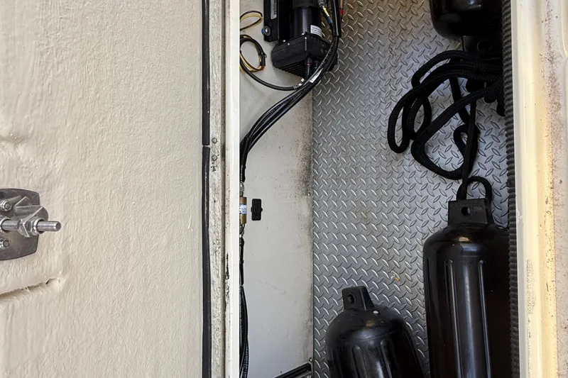  Yacht Photos Pics Storage compartment of 2024 Ranger Tugs R31CB with ropes and fenders on diamond plate floor.