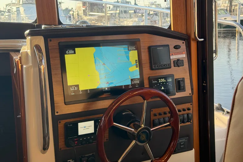  Yacht Photos Pics 2024 Ranger Tugs R31CB helm with navigation display and wooden steering wheel.
